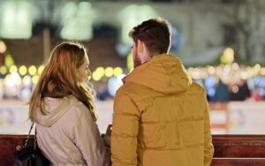 merry christmas, couple, young people, people, blonde, friendship, together, talking, fence, winter, holiday, lights, ornaments, decoration, back view, snapshot